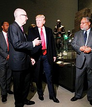 
President Trump, center, talks with David Skorton, left, secretary of the Smithsonian Institution, and Lonnie G. Bunch III, founding director of the Smithsonian’s National Museum of African American History and Culture in Washington, during Tuesday’s tour. 