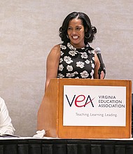 Jahana Hayes, center, the 2016 National Teacher of the Year, reacts to remarks during her talk last Friday at the Teachers of Color Summit in Downtown. Sharing the dais are, left, Dr. James J. Fedderman, vice president of the Virginia Education Association, and Jim Livingston, president of the statewide teachers group. 