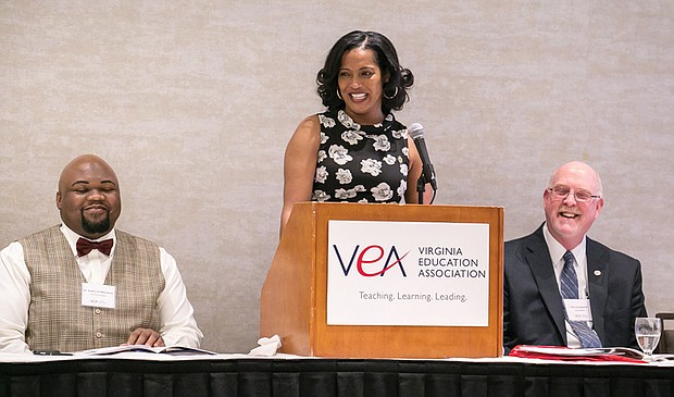 Jahana Hayes, center, the 2016 National Teacher of the Year, reacts to remarks during her talk last Friday at the Teachers of Color Summit in Downtown. Sharing the dais are, left, Dr. James J. Fedderman, vice president of the Virginia Education Association, and Jim Livingston, president of the statewide teachers group. 