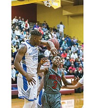 John Marshall High sophomore De’Marr McRae, left, elbow blocks a shot by George Wythe High freshman Ikechi Chantilou during last Friday’s Conference 26 championship game in Petersburg. The John Marshall Justices beat the George Wythe Bulldogs 56-53. Both teams are playing in the 3A East Regional playoffs.
