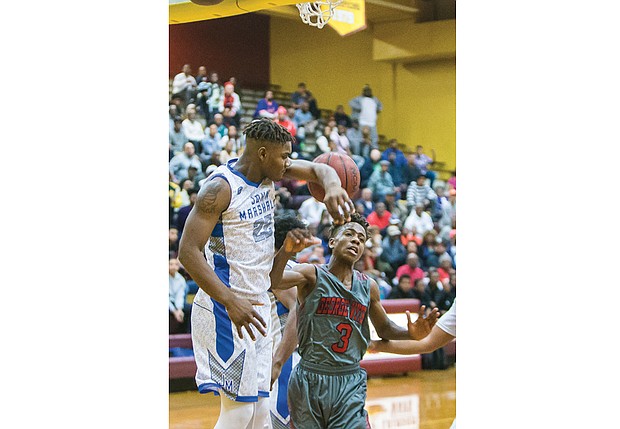 John Marshall High sophomore De’Marr McRae, left, elbow blocks a shot by George Wythe High freshman Ikechi Chantilou during last Friday’s Conference 26 championship game in Petersburg. The John Marshall Justices beat the George Wythe Bulldogs 56-53. Both teams are playing in the 3A East Regional playoffs.
