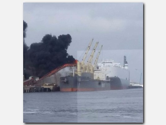 Port Arthur firefighters are still investigating what caused a conveyer belt fire near a cargo ship.
