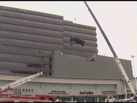 A day after a car came flying off a parking garage and crashed into the shopping center seven stories below, …