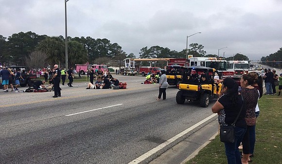 Twelve Alabama students were injured Tuesday when a car plowed into a marching band during a Mardi Gras parade