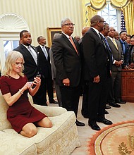 As President Trump meets Monday with presidents and chancellors of historically black colleges and universities, Kellyanne Conway, counselor to the president, sits shoeless on an Oval Office sofa working on her cellphone. The photo went viral.
