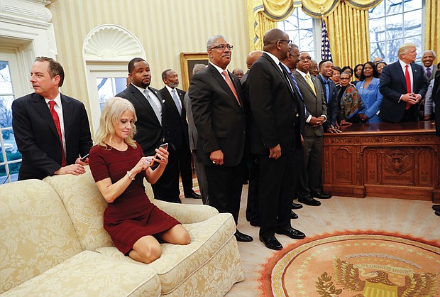 As President Trump meets Monday with presidents and chancellors of historically black colleges and universities, Kellyanne Conway, counselor to the president, sits shoeless on an Oval Office sofa working on her cellphone. The photo went viral.