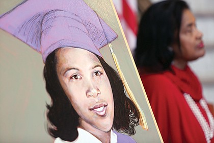 
Joan Johns Cobbs, right, listens as Gov. Terry McAuliffe delivers remarks during a dedication ceremony for the Barbara Johns Building, named for her sister, pictured in the portrait, left, in the building’s lobby at 202 N. 9th St. 
