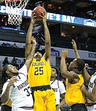 
Bowie State University’s Yohance Fleming goes up for a basket against Virginia Union University’s Tavon Mealy, left, during last Thursday’s quarterfinal game at the CIAA Tournament. Bowie State knocked VUU out of the tournament, defeating the Panthers 84-78. The Bulldogs went on to win the tournament 62-54 over Fayetteville State University.