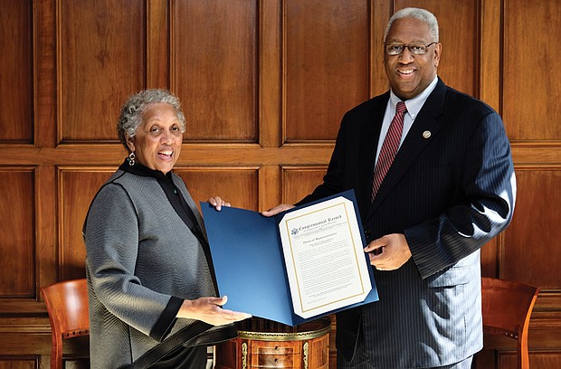 Richmond Free Press Publisher Jean P. Boone receives a citation from 4th District Congressman A. Donald McEachin — a copy of his remarks placed in the Congressional Record commemorating the newspaper’s 25th anniversary. 
The Congressional Record is the official record of the proceedings and debates of the U.S. House of Representatives and U.S. Senate. In remarks he delivered Feb. 13 on the House floor, Rep. McEachin lauded the independent, black-owned Free Press as a “voice for all people since its inception.” He recalled the newspaper’s late founder, Raymond H. Boone, and noted that the Free Press “has altered the media landscape of Richmond, the former capital of the Confederacy,” with its award-winning coverage. 
The Free Press, he said, “does not only chronicle history, it has made history for the last 25 years.” The newspaper celebrated its silver anniversary on Jan. 16. 