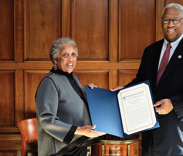 Richmond Free Press Publisher Jean P. Boone receives a citation from 4th District Congressman A. Donald McEachin — a copy of his remarks placed in the Congressional Record commemorating the newspaper’s 25th anniversary. 
The Congressional Record is the official record of the proceedings and debates of the U.S. House of Representatives and U.S. Senate. In remarks he delivered Feb. 13 on the House floor, Rep. McEachin lauded the independent, black-owned Free Press as a “voice for all people since its inception.” He recalled the newspaper’s late founder, Raymond H. Boone, and noted that the Free Press “has altered the media landscape of Richmond, the former capital of the Confederacy,” with its award-winning coverage. 
The Free Press, he said, “does not only chronicle history, it has made history for the last 25 years.” The newspaper celebrated its silver anniversary on Jan. 16. 