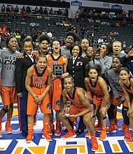 The Virginia State University women’s basketball team celebrates last Friday after making it to the CIAA finals