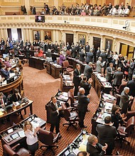 Senators applaud their young pages in the gallery on the session’s opening day. 