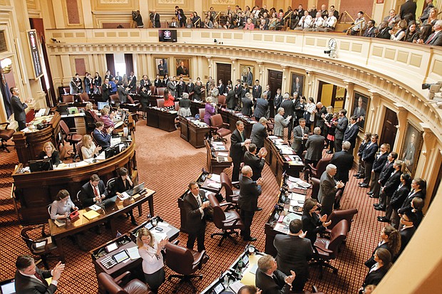 Senators applaud their young pages in the gallery on the session’s opening day. 