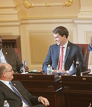 Petersburg Sen. Rosalyn R. Dance, right, introduces new Sen. Lionel Spruill Sr. of Chesapeake on the Senate floor.  Looking on are Sen. T. Montgomery “Monty” Mason of Williamsburg, front left, and Sen. Jeremy S. McPike of Woodbridge, center. 