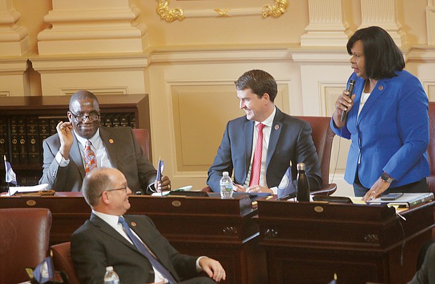 Petersburg Sen. Rosalyn R. Dance, right, introduces new Sen. Lionel Spruill Sr. of Chesapeake on the Senate floor.  Looking on are Sen. T. Montgomery “Monty” Mason of Williamsburg, front left, and Sen. Jeremy S. McPike of Woodbridge, center. 