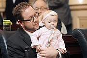 Delegate Joseph R. Yost of Pearisburg proudly shows the House chamber to Virginia, his 7-month-old daughter.