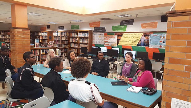 Those involved with the project include, forefront left to right, Franklin Military Academy students Lil’Meal Boyd, Saki Nowacki, Shakiyah Bolden-Jones and Alyssa Brown. Also, rear left to right, teacher Megan Scott, Principal Sheron Carter-Gunter, Commandant Carlton Day, teacher Danielle Bowers and Sen. Tim Kaine’s Central Virginia regional director, Tyee Mallory. Col. Day and Ms. Mallory are not traveling to England.  