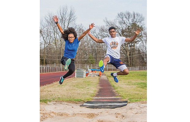 Kendra Scott and Jordin Poindexter, both juniors at Armstrong High School, show off their track skills after strong finishes in the State Indoor Track & Field Championships in Salem.