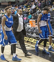 
John Marshall High Coach Ty White, above, walks to the locker room with his dejected ballplayers after the Justices’ 72-59 loss March 2 to Roanoke’s Northside High School during a quarterfinal game at the state 3A tournament at the Siegel Center. At right, George Wythe High’s Antonio Bridy snags the ball during the Bulldogs’ victorious quarterfinal match against Heritage High School of Lynchburg on March 2. The Bulldogs fell to I.C. Norcom High School of Portsmouth during the semifinals on March 3. 