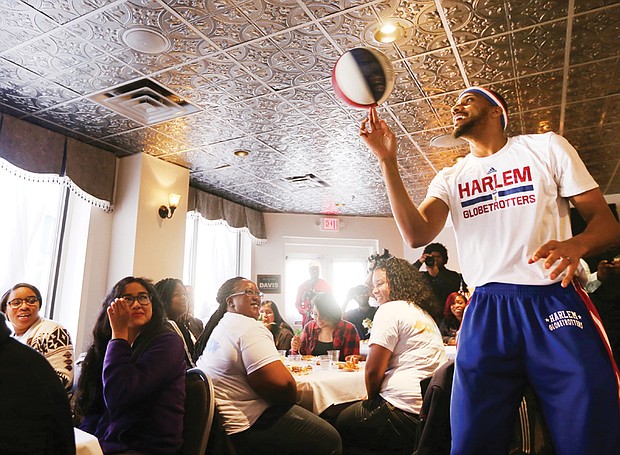 Zeus plays to crowd at Mama J’s //

Zeus McClurkin, a member of the legendary Harlem Globetrotters basketball team, captivates the room of 37 George Wythe High School honor students during a special luncheon Wednesday honoring the young people at Mama J’s Kitchen in Jackson Ward. The Columbus, Ohio, native engaged the students with a pep talk before showing off his skills. The event was part of Richmond’s first Black Restaurant Week highlighting black-owned and operated restaurants in the city. The promotion, with fixed-price lunch and dinner specials at 20 restaurants, runs through Sunday, March 12. Mr. McClurkin and the Harlem Globetrotters have an exhibition game 7 p.m. Friday, March 10, at the Richmond Coliseum.