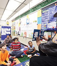 Who is that ‘cat in the hat?’ // 
First-graders at Overby-Sheppard Elementary get a treat — Richmond Sheriff C.T. Woody Jr. reading Dr. Seuss’ “The Cat in the Hat” to teacher Rita Robinson’s class. The event last Friday was part of Read Across America, a celebration of reading and Dr. Seuss’ birthday, sponsored by the National Education Association. Under volunteer coordinator Lola McDowell, more than 75 “celebrity” readers from the Richmond community read to students at Overby-Sheppard, including members of Richmond City Council and the School Board, Virginia Commonwealth University professors, actor Daphne Maxwell Reid, University of Richmond President Ronald A. Crutcher, state Secretary of Education Dietra Y. Trent, comedian Micah “Bam-Bamm” White and Delegate Jeff Bourne, former chair of the Richmond School Board. Elementary schools across the city hosted celebrations last week, with some observing the day this week.
