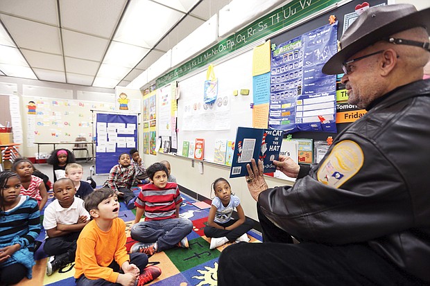 Who is that ‘cat in the hat?’ // 
First-graders at Overby-Sheppard Elementary get a treat — Richmond Sheriff C.T. Woody Jr. reading Dr. Seuss’ “The Cat in the Hat” to teacher Rita Robinson’s class. The event last Friday was part of Read Across America, a celebration of reading and Dr. Seuss’ birthday, sponsored by the National Education Association. Under volunteer coordinator Lola McDowell, more than 75 “celebrity” readers from the Richmond community read to students at Overby-Sheppard, including members of Richmond City Council and the School Board, Virginia Commonwealth University professors, actor Daphne Maxwell Reid, University of Richmond President Ronald A. Crutcher, state Secretary of Education Dietra Y. Trent, comedian Micah “Bam-Bamm” White and Delegate Jeff Bourne, former chair of the Richmond School Board. Elementary schools across the city hosted celebrations last week, with some observing the day this week.
