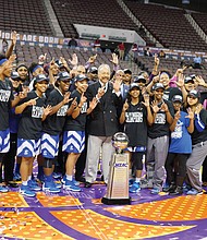 
The Hampton University Lady Pirates celebrate their sixth MEAC title under Coach David Six that was clinched in last Saturday’s 52-49 victory over Bethune-Cookman University at the Norfolk Scope. At the center of the celebration is Hampton University President William R. Harvey.