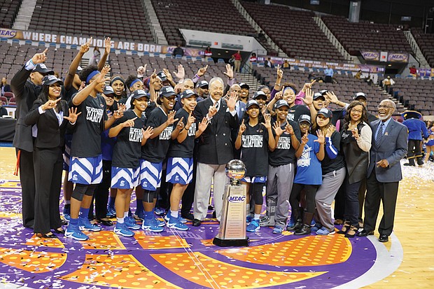 
The Hampton University Lady Pirates celebrate their sixth MEAC title under Coach David Six that was clinched in last Saturday’s 52-49 victory over Bethune-Cookman University at the Norfolk Scope. At the center of the celebration is Hampton University President William R. Harvey.