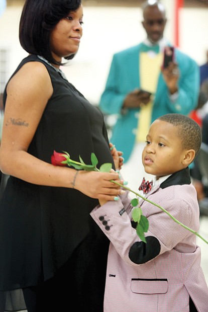 First dance
Keon Pleasant, 6, shares a first dance with his mother, Quaneisha Tyler, at the Mother/Son, Father/Daughter Dance last Friday for J.L. Francis Elementary School students and their parents. The dance was held at Second Baptist Church on Broad Rock Boulevard, with youngsters presenting roses to their parents. Princes and princesses of the dance were crowned. Keon’s grandfather, Anthony Bailey, documents the special occasion in the background.