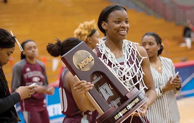 Virginia Union University’s Lady Walker poses with the victory trophy and net Monday night after the Lady Panthers defeated California University of Pennsylvania to win the NCAA Division II Atlantic Region title. Lady Walker scored 32 points in the regional championship game and was named to the All-Atlantic Region team.  