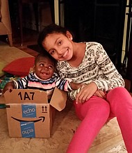 	Baby Dominique was born with a parasitic twin attached to her back from the waist down. She was fostered by a US family so she could have complicated surgery.
