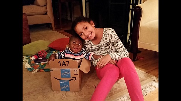 	Baby Dominique was born with a parasitic twin attached to her back from the waist down. She was fostered by a US family so she could have complicated surgery.
