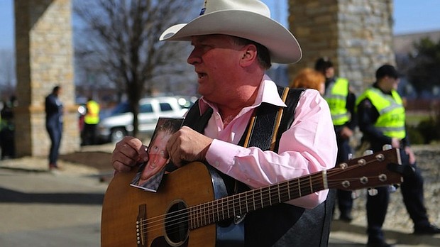 	Kraig Moss, a supporter of Donald Trump during the campaign, sings a song outside a truck with a Trump painting last year in Iowa. Now, he regrets doing so.