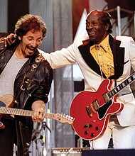 Chuck Berry, right, performs his highly popular tune “Johnny B. Goode” with Bruce Springsteen to open The Concert for the Rock & Roll Hall of Fame in September 1995 at Cleveland Stadium.