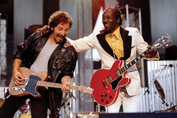 Chuck Berry, right, performs his highly popular tune “Johnny B. Goode” with Bruce Springsteen to open The Concert for the Rock & Roll Hall of Fame in September 1995 at Cleveland Stadium.