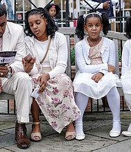 Freddie Royal takes a moment to peruse the activity schedule as he sits with his daughters, from left, Kyra, Amirah and Jada.