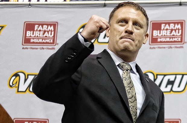 Virginia Commonwealth University’s new head basketball coach, Mike Rhoades, greets fans and the media Wednesday during his official public introduction at the Siegel Center. Rhoades, who was an assistant coach at VCU under former Coach Shaka Smart, is leaving the head coach role at Rice University to lead the Rams.