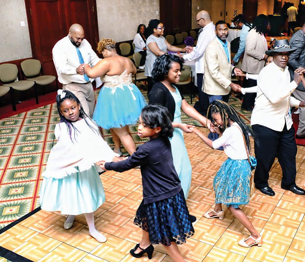 Father-daughter couples practice their salsa steps on the dance floor in the Massey Conference Center Auditorium at the garden’s Kelly Education Center.
