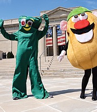 
“Gumby” and “Mr. Potato Head” strike a pose in front of the Virginia Historical Society on North Boulevard Wednesday as they prepared to take part in a promotional video for the society’s “Toys of the ’50s, ’60s and ’70s” exhibition. Visitors can see popular toys from those decades, learn about their inventors and hear the memories of people who played with the games through the exhibit that runs through Labor Day. Olivia Lukanuski is inside the Gumby suit, while Jennifer Nesossis is the lively Mr. Potato Head.