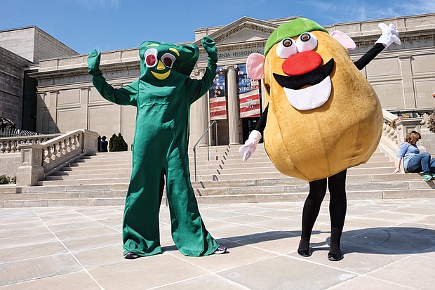 
“Gumby” and “Mr. Potato Head” strike a pose in front of the Virginia Historical Society on North Boulevard Wednesday as they prepared to take part in a promotional video for the society’s “Toys of the ’50s, ’60s and ’70s” exhibition. Visitors can see popular toys from those decades, learn about their inventors and hear the memories of people who played with the games through the exhibit that runs through Labor Day. Olivia Lukanuski is inside the Gumby suit, while Jennifer Nesossis is the lively Mr. Potato Head.