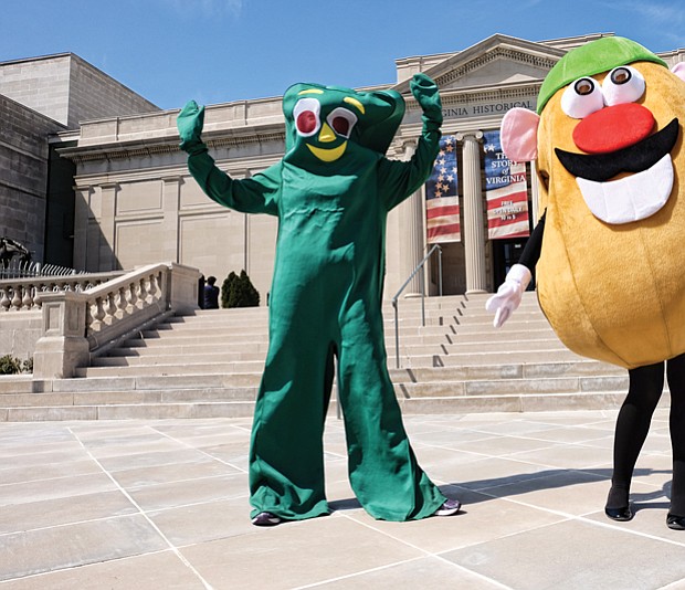 
“Gumby” and “Mr. Potato Head” strike a pose in front of the Virginia Historical Society on North Boulevard Wednesday as they prepared to take part in a promotional video for the society’s “Toys of the ’50s, ’60s and ’70s” exhibition. Visitors can see popular toys from those decades, learn about their inventors and hear the memories of people who played with the games through the exhibit that runs through Labor Day. Olivia Lukanuski is inside the Gumby suit, while Jennifer Nesossis is the lively Mr. Potato Head.