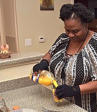 Martha Daniels pours juice in her kitchen that's provided by Meals on Wheels. Daniels, who's diabetic, receives meals each week that help manage her diabetes.  
