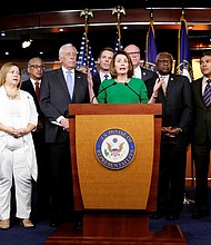 
House Minority Leader Nancy Pelosi of California, center, proclaims victory with fellow Democratic members of the House of Representatives after a bill to repeal and replace Obamacare was pulled from consideration because the GOP lacked the votes for passage.