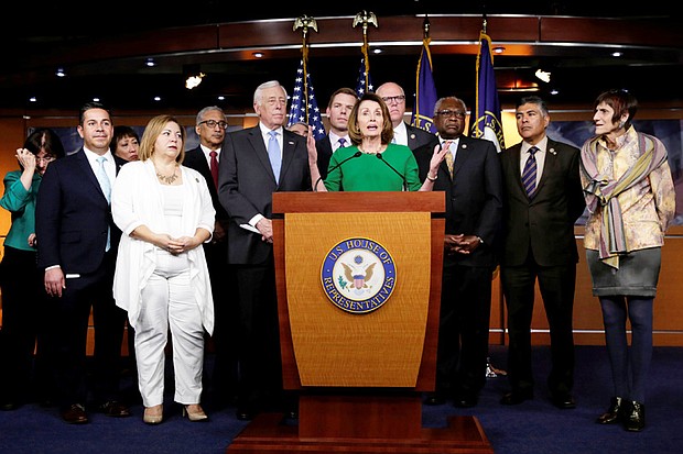 
House Minority Leader Nancy Pelosi of California, center, proclaims victory with fellow Democratic members of the House of Representatives after a bill to repeal and replace Obamacare was pulled from consideration because the GOP lacked the votes for passage.