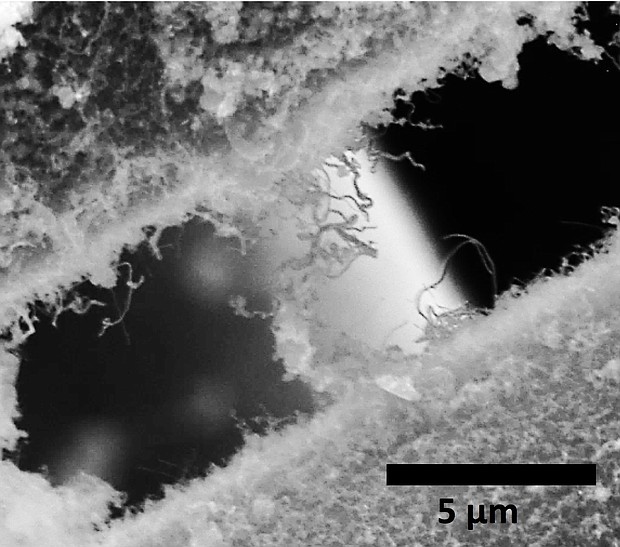 Silicon carbide nanotubes attached to separate silicon carbide fibers, used by NASA, entangle each other in this electron microscope image. The material created at Rice University is intended for a ceramic composite that would make rocket engines stronger, lighter and better able to withstand extreme heat. (Credit: Ajayan Research Group/Rice University)