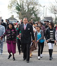 Pastor Stephen A. Parson Sr., center, leads supporters into the 8 a.m. service Sunday at the Richmond Christian Center, which he founded 34 years ago. This apparently was his first appearance at a service in the South Side church in two years.