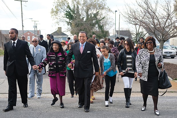 Pastor Stephen A. Parson Sr., center, leads supporters into the 8 a.m. service Sunday at the Richmond Christian Center, which he founded 34 years ago. This apparently was his first appearance at a service in the South Side church in two years.