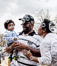 Bubbles, bubbles everywhere
Solomon and Sabrena Burison surround their 8-month-old son, Jacion, with a bevy of bubbles during the grand reopening of Maymont Farm last Sunday. The youngster carefully eyes the floating orbs. Please see more photos, B2. 
