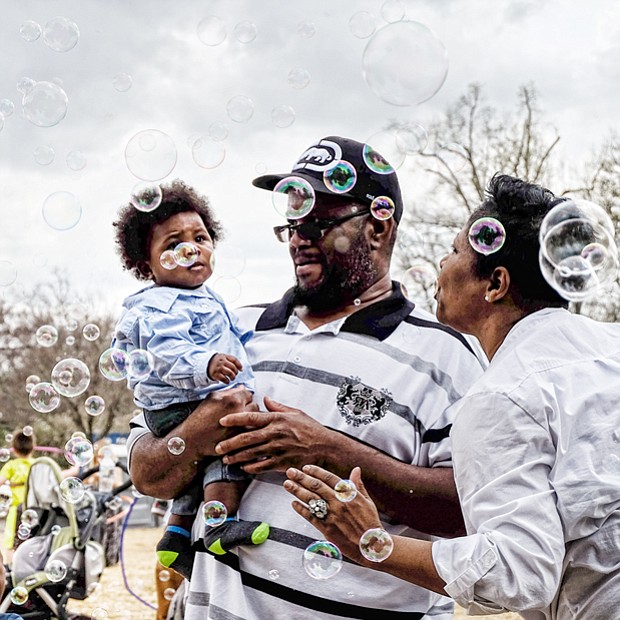 Bubbles, bubbles everywhere
Solomon and Sabrena Burison surround their 8-month-old son, Jacion, with a bevy of bubbles during the grand reopening of Maymont Farm last Sunday. The youngster carefully eyes the floating orbs. Please see more photos, B2. 
