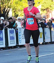 With a 2.6-mile head start, Dash for Cash runner Kathy Hoverman, right, makes her way to the finish line, where she beat the Monument Avenue 10K first place finisher and collected $2,500.
